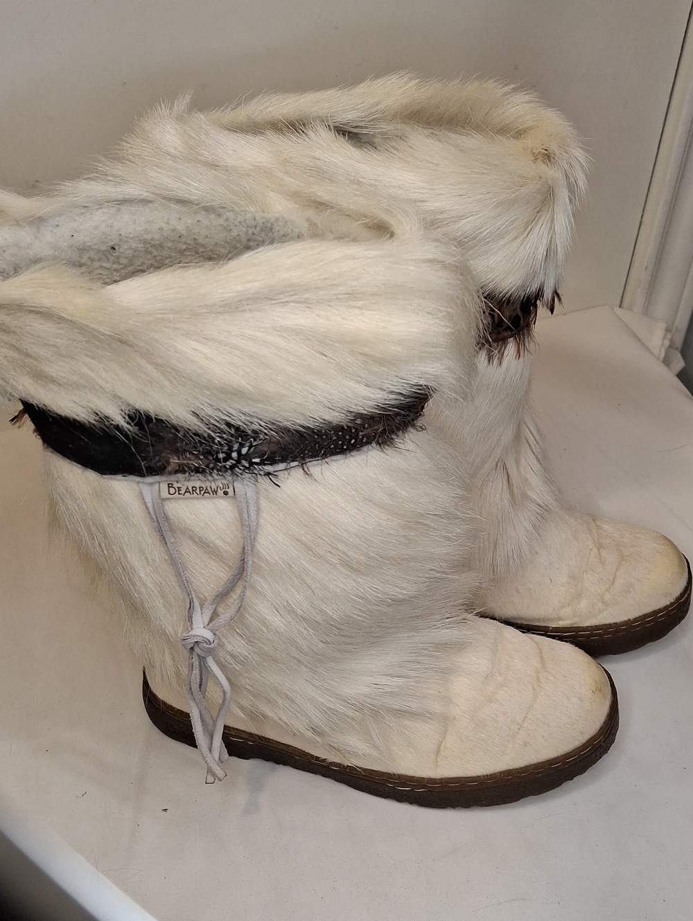 BearPaw Kola ll Genuine White Goat Fur Winter Boots. Pheasant Feather Trim atTop